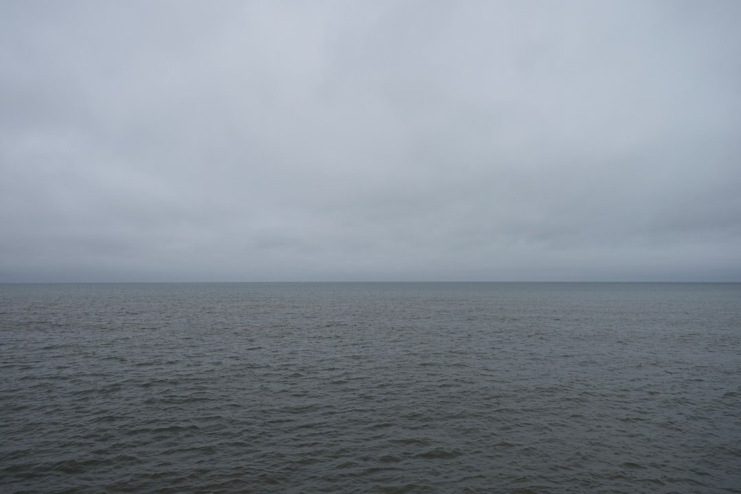 Flat Danish coastal landscape with grey sea and overcast sky