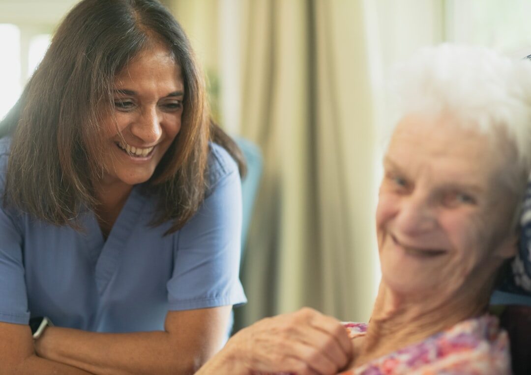 nurse helping elderly person