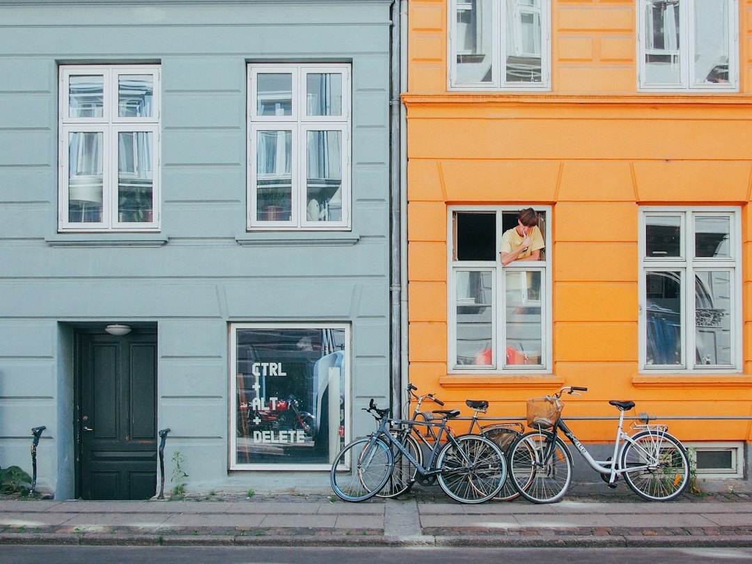Narrow Copenhagen street with traditional colorful facades and parked bicycles
