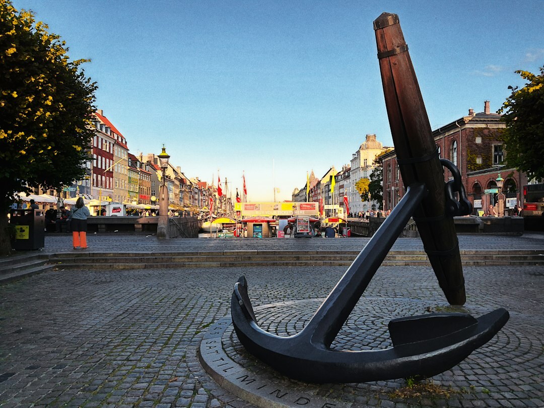 Danes walking across a public square in a Danish city on an overcast afternoon